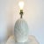 Amazing vintage postmodern ceramic table lamp. Features an off white iridescent finish over a scalloped body.