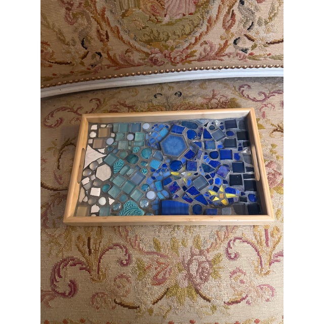 A very lovely hand decorated tile mosaic serving tray. The tray portion is mad of bamboo