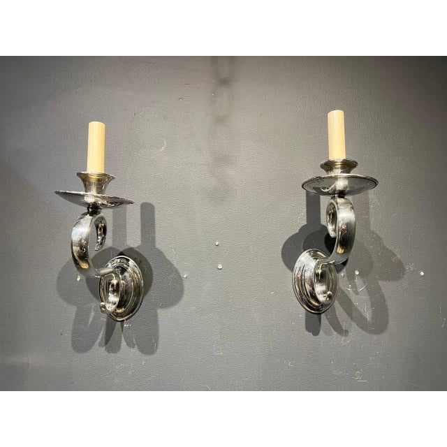 A pair of circa 1940’s silver plated sconces with scrolled arms.