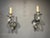 A pair of circa 1940’s silver plated sconces with scrolled arms.