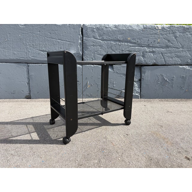 Black Serving or Bar Cart from Mascagni, Made in Italy, Foldable. Wood, Glass. When folded Cart is 9" wide and 35.5' high....