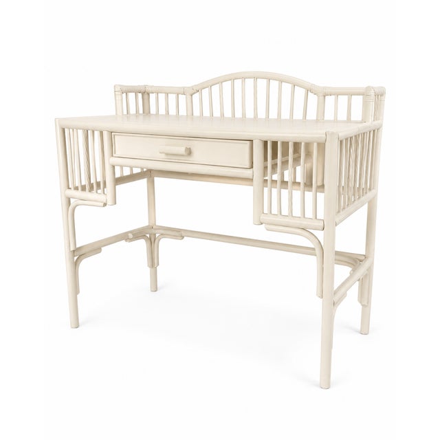 Charming vintage rattan writing desk featuring graceful gallery-style sides and back, slender spindle detailing, wrapped...