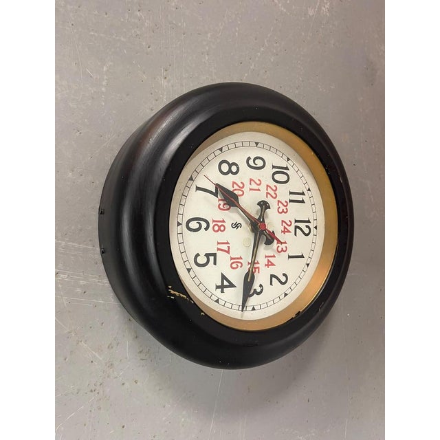 A rare and highly distinctive Siemens Halske industrial wall clock, featuring a beautifully graphic 24-hour dial dating...