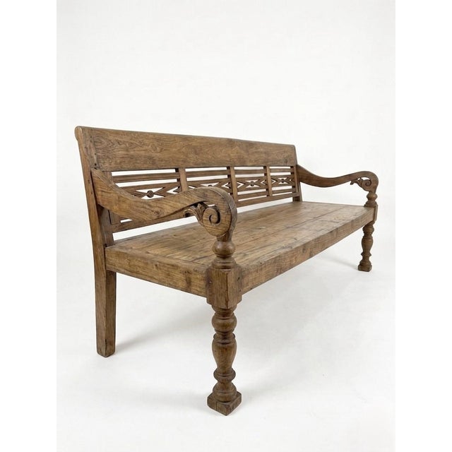 This striking vintage bench is a masterclass in rustic elegance, blending substantial architectural form with delicate...