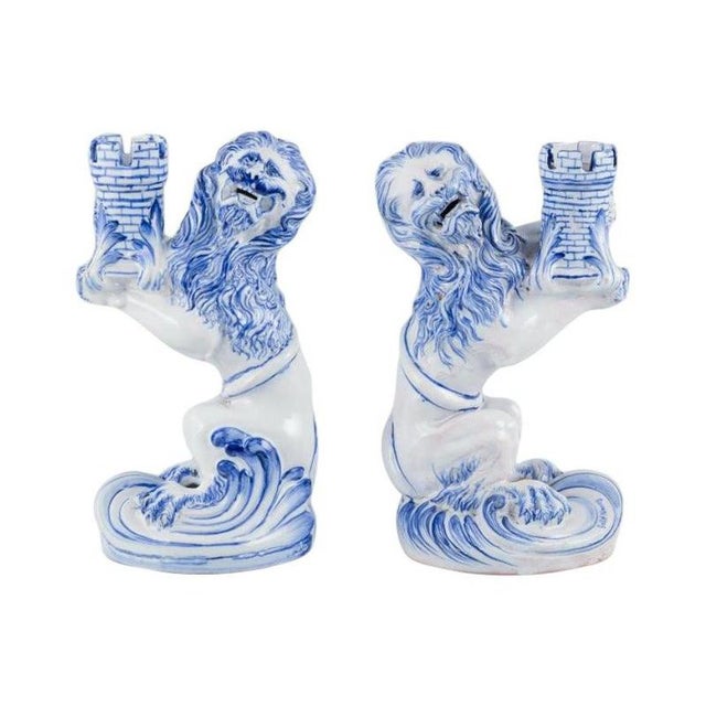 Emile Gallé for Nancy, St Clement. A pair of early and large blue and white faience candle holders modelled as a seated...