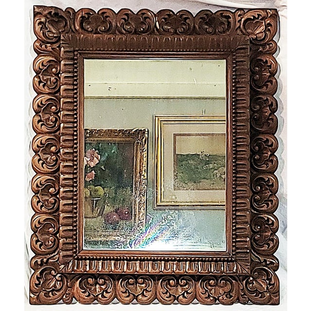 Beautifully hand carved pair of mahogany mirrors with Louis XIV-XV motifs, acanthus leaves and shells adorn this pair....
