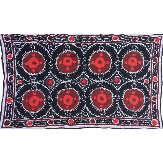 “Suzani” derives from the Persian word "suzan" for "needle" and refers to bright silk embroidered wall hangings and...