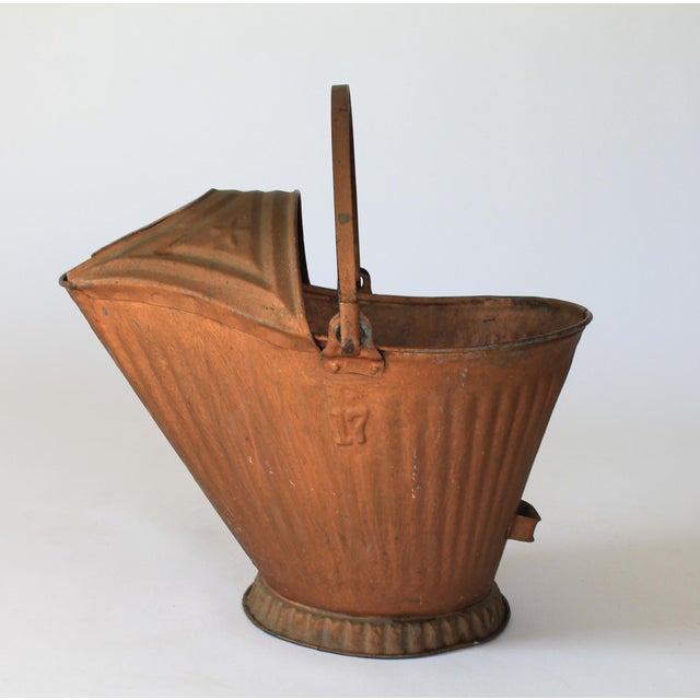 Antique copper tone coal scuttle bucket. Stamped with the number 17 on the side. Overall wear from age and use. No makers...