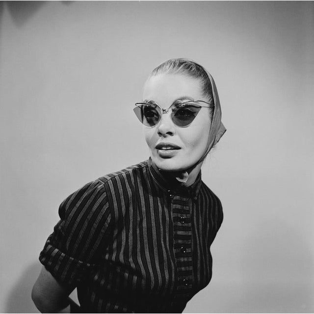 Cat's Eye Specs A young woman wearing cat's eye sunglasses with a headscarf, 1956. (Photo by Archive Photos/Getty Images)...