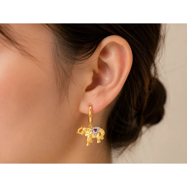 Metal: 14K Yellow Gold Primary Stones: Rubies Accent Stones: Diamonds 0.1 CTW Dimensions: 1 inch long x 5/8 inch wide...