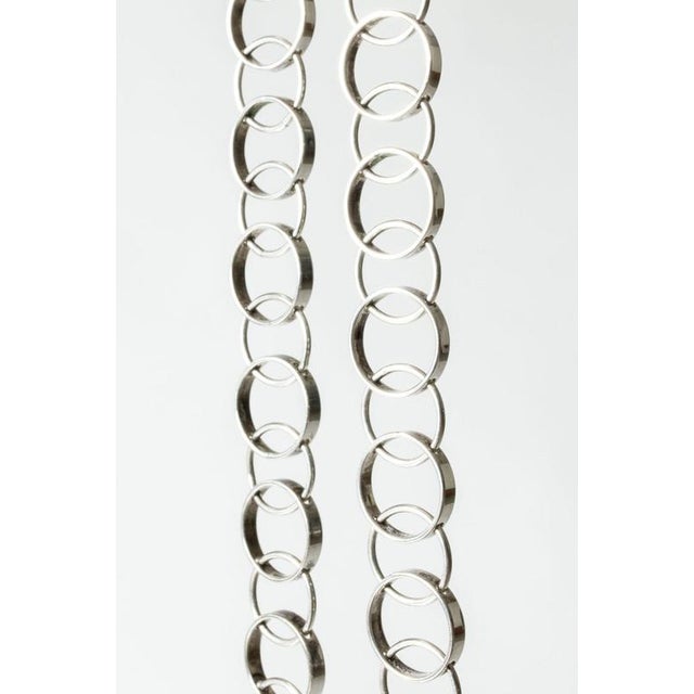 Elegant silver collier in a sophisticated design of interlocking circles, comfortable in a shorter length that lies close...