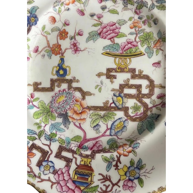 An early antique Minton style Chinese Tree chinoiserie plate with gilt scalloped edge. Chinese tree with vases of peonies...