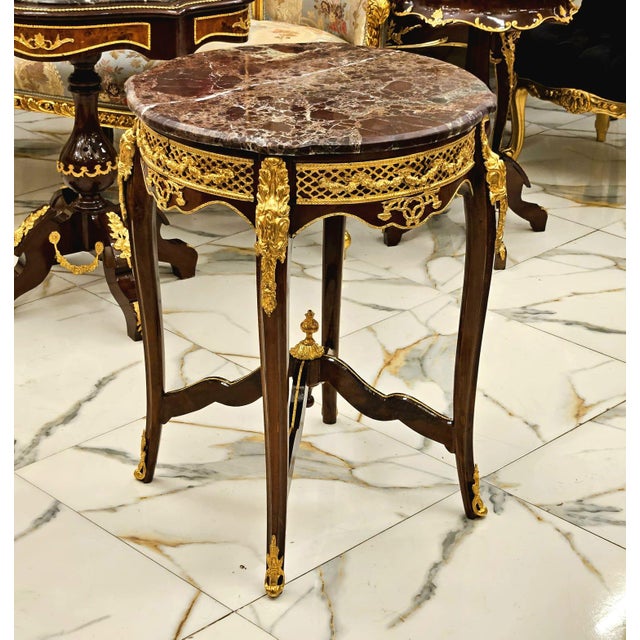 An exquisite French Louis XV style accent table showcasing a beautifully crafted marquetry top, elegant cabriole legs, and...