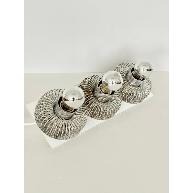 Philippe Rogier Three-light spring-loaded wall sconce for Luminor/Oxar White lacquered and chrome-plated metal France,...