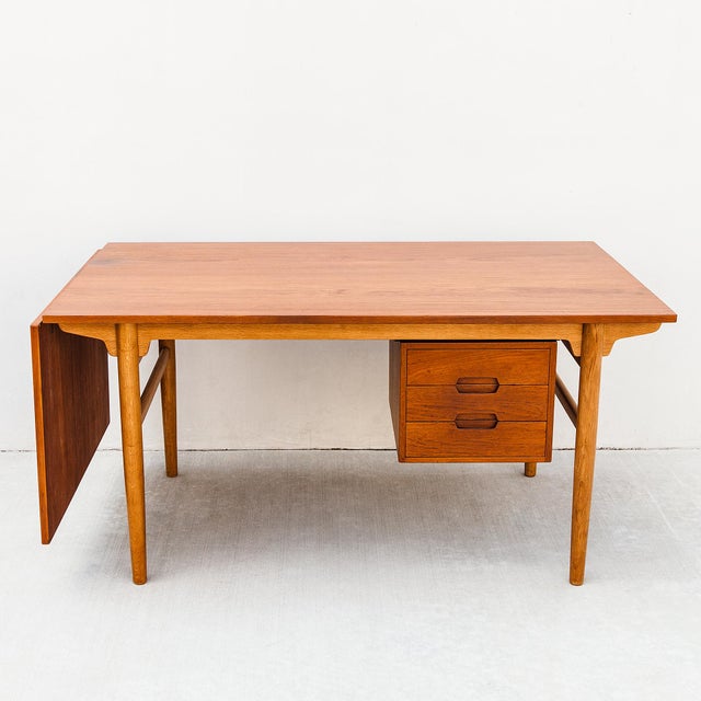 Large Scandinavian mid century modern teak and oak drop leaf desk, made in Denmark c. 1960s. Features a solid oak frame...