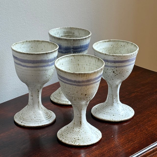 Offering a gorgeous vintage set artisinal stoneware goblets from the mid/late-20th century. This set of four beautifully...