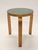 Artek's model 60 stool, design by Alvar Aalto. Beautifully patinated birch with rare green linoleum top. In good used...
