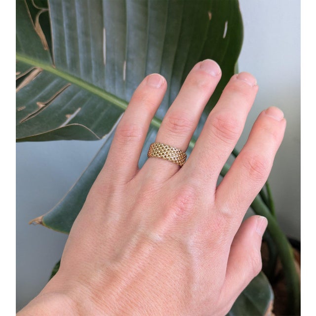 A comfortable flex band in solid 14K yellow gold, its flexible construction moving gently with the finger for all-day...
