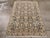 This mid-20th-century Persian Malayer rug presents a finely organized allover floral composition across a muted blue-grey...