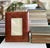 Handcrafted vintage picture frame wrapped in richly textured genuine leather and embossed with an elegant leaf motif. The...