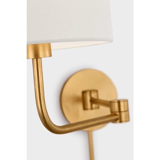 Go Lightly Swing Arm Wall Light in Gild with Linen Shade Designer: Barbara Barry Finish: Gild Height: 15.75" Width: 8.75"...