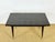 Elegant extendable art deco table, crafted from macassar ebony with exceptional contrasting grain. its tabletop boasts a...