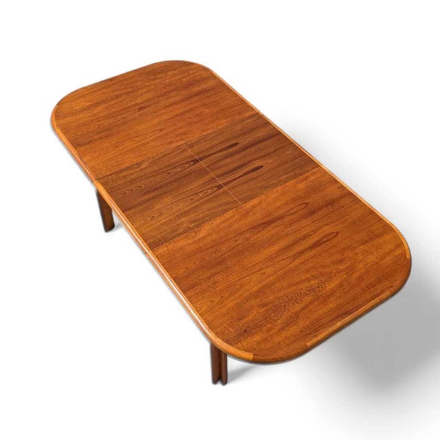 Danish Mid-Century Teak Butterfly-Leaf Dining Table. A vintage Danish-style teak dining table with a clean rounded-...