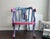 One of a kind hand painted accent chair refinished in a bold contemporary palette of soft blue and vibrant pink. This...