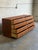 This 8-drawer lowboy features a clean geometric silhouette with flush drawer fronts and a recessed plinth base. The...