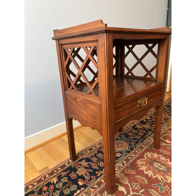 Bedside table with graceful carved gallery, latticework back and side inserts. Single drawer above shaped apron. This item...