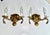 Pair of European two-light neoclassic style brass wall sconces with dolphin and claim shell motif. Expertly crafted with...