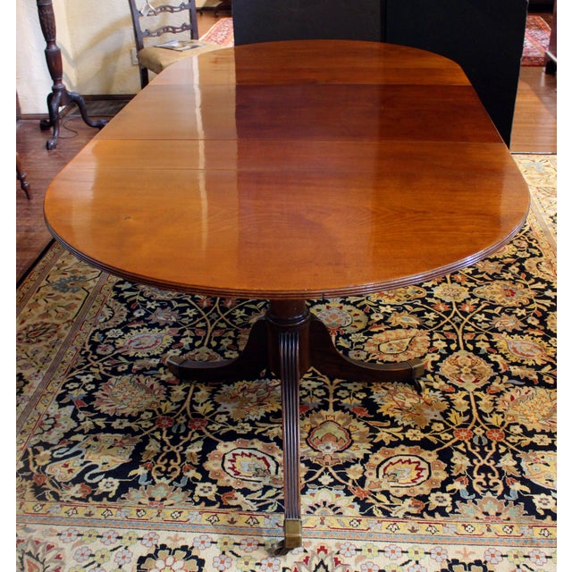 Circa 1930 double pedestal dining table with leaf, English. Solid mahogany. Georgian style. Integral extension system...