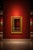 Ornate giltwood-style wall mirror with an Egyptian Revival inspired design. The rectangular frame features a wide gold-...