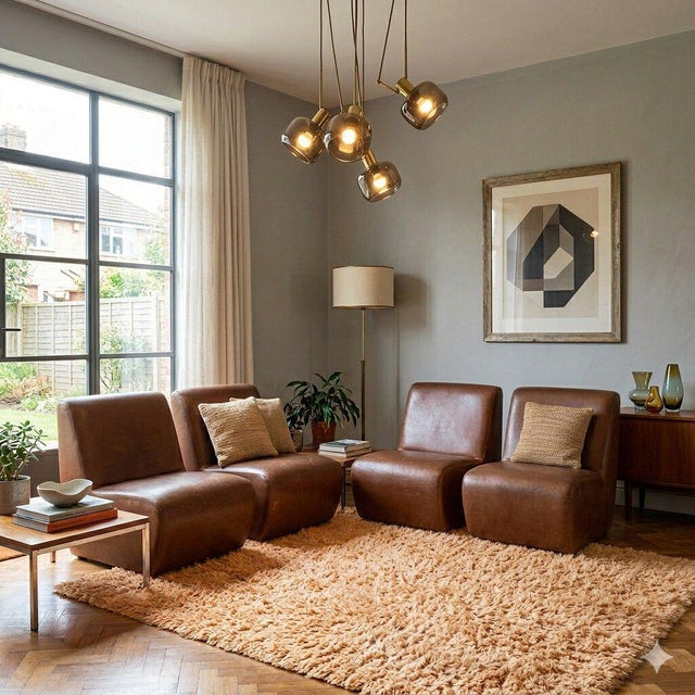 Set of four modular vintage armchairs with leatherette upholstery. Decent condition. This piece is attributed to the...
