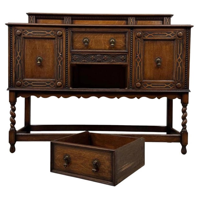An impressive early 20th-century English sideboard, finely crafted from oak in the Jacobean Revival style and...