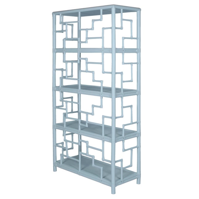 Elegantly designed, this étagère features a rattan frame, rawhide bindings and four wood shelves. The intricate rattan...