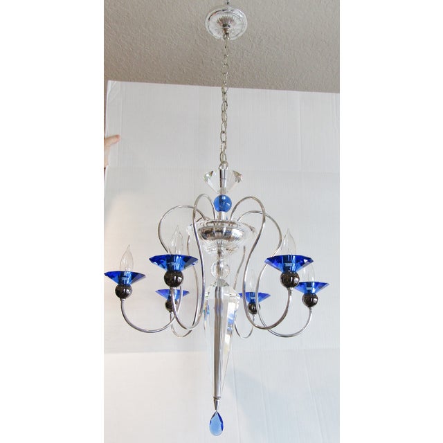 Beautiful Schonbek Rhiannon 6 Light Sapphire Chandelier This chandelier is made by Schonbek. It has a silver frame mounted...