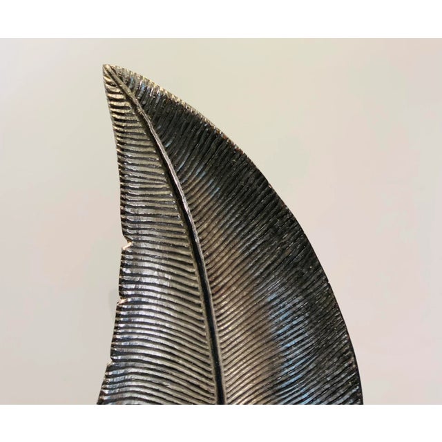 Elegant Polished Nickel Leaf Sculpture, black marble stand, please ignore the reflection in the stand, showroom floor sample