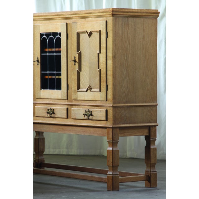 A smaller-scale oak display cabinet or vitrine with a strong traditional Danish character. Its compact proportions make it...