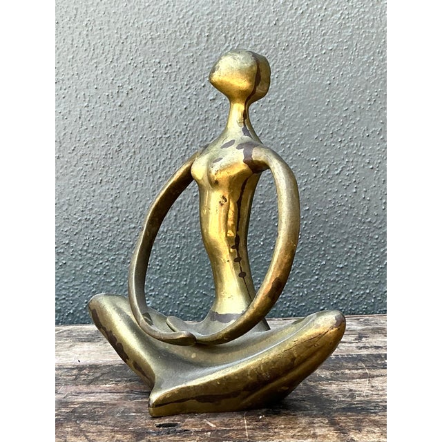 This captivating vintage sculpture depicts a stylized female figure in a state of serene meditation. Exemplifying the...