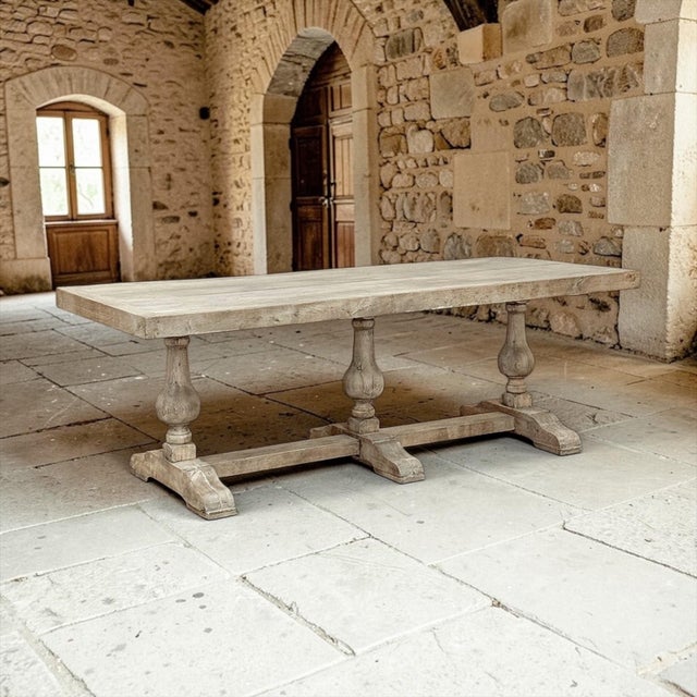 A substantial Italian trestle table crafted in solid oak, presenting a strong architectural presence balanced by rustic...