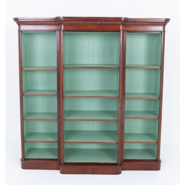 A large and impressive Victorian mahogany breakfront open bookcase, standing upon a substantial plinth base Circa 1860...