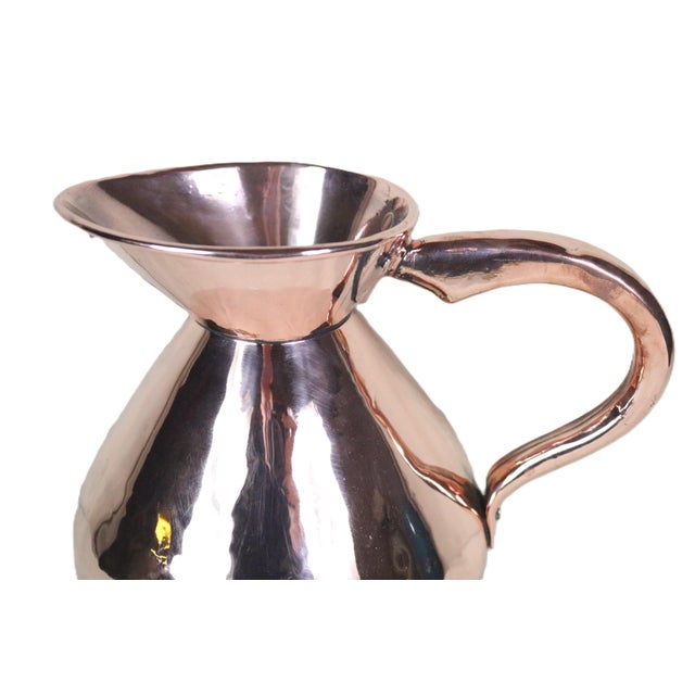 A traditional English copper serving jug with a gallon volume dating from the late 19th century. This shape is commonly...