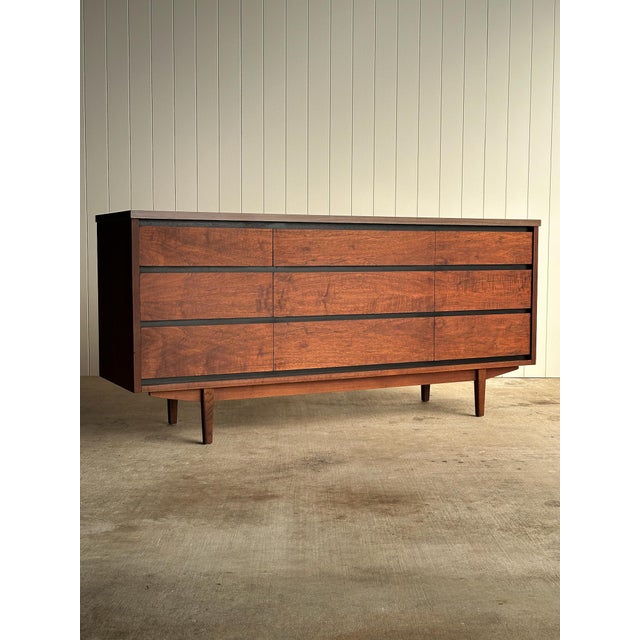 Vintage nine-drawer dresser by Stanley with solid walnut drawer fronts, veneered sides, and original laminate top....