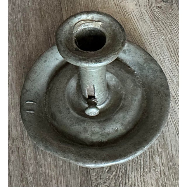 Antique pewter chamber-stick candle holder possibly dating from the 19th century. It has a wide base to catch wax...