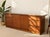 A substantial vintage mid-century modern credenza featuring a warm walnut finish, generous storage, and a beautifully...