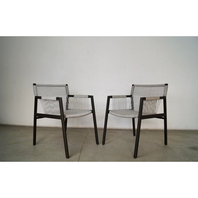 Pair of outdoor patio arm chairs for sale. They are in excellent condition, and were manufactured by Four Hands. These are...