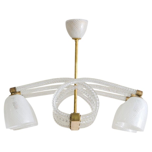 A 1940s Murano glass chandelier attributed to the esteemed Ercole Barovier. Six looped canes of clear Murano glass coil...