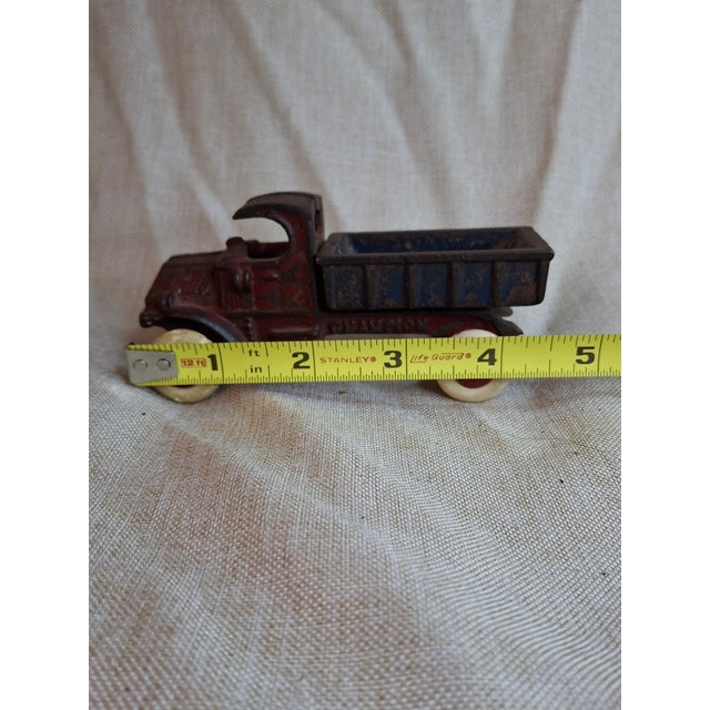 This is a museum-quality example of the Champion Hardware Co. "Bulldog" Mack dump truck. This No. 14 miniature scale model...