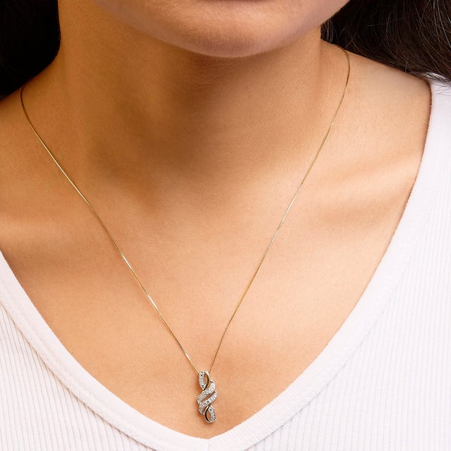 Make her special day an unforgettable one by presenting her this dazzling pendant. Fashioned in the swirl shape, the...